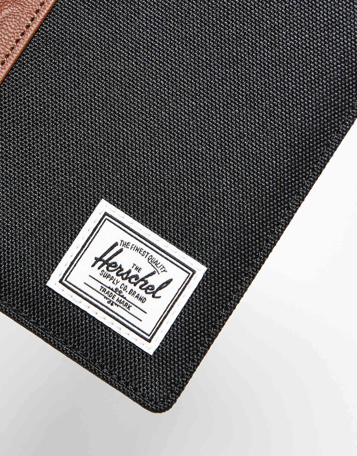 Herschel Supply Co raynor passport holder in black/tan