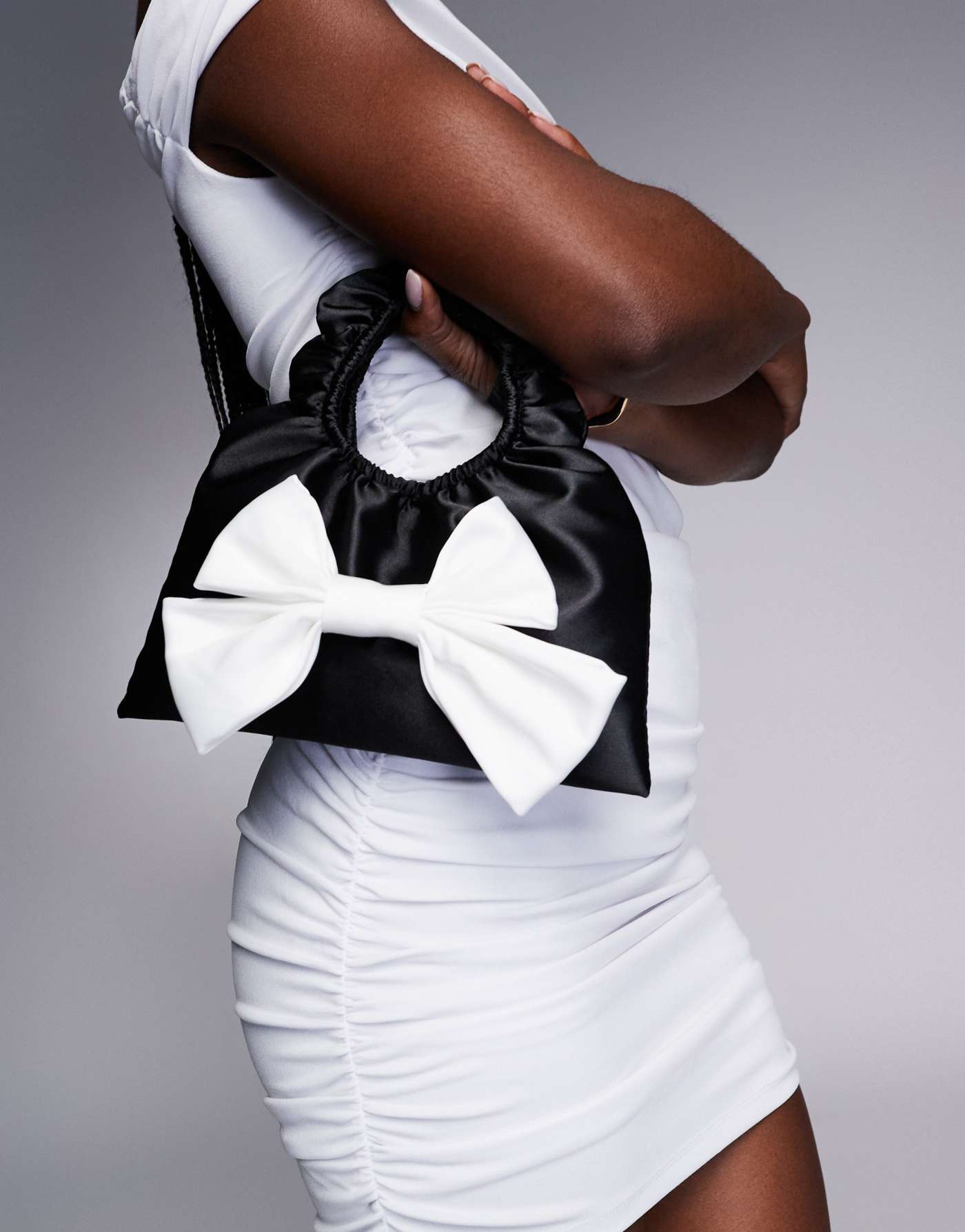 True Decadence bow front satin bag in black & white