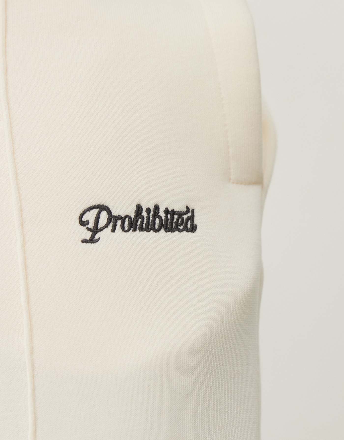 Prohibited script logo straight leg jogger in cream