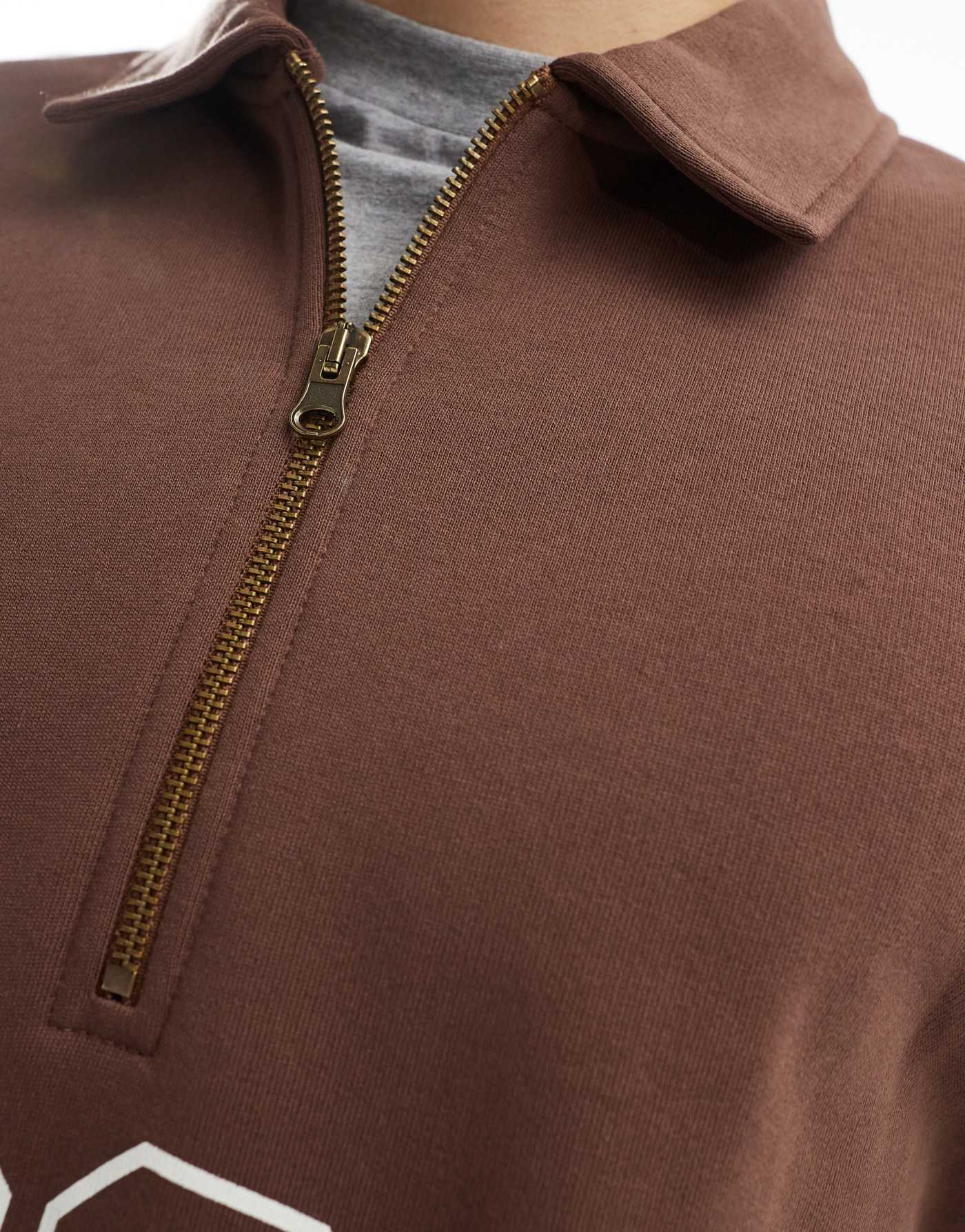 ASOS DESIGN boxy oversized polo sweatshirt with print and tipping detail in brown