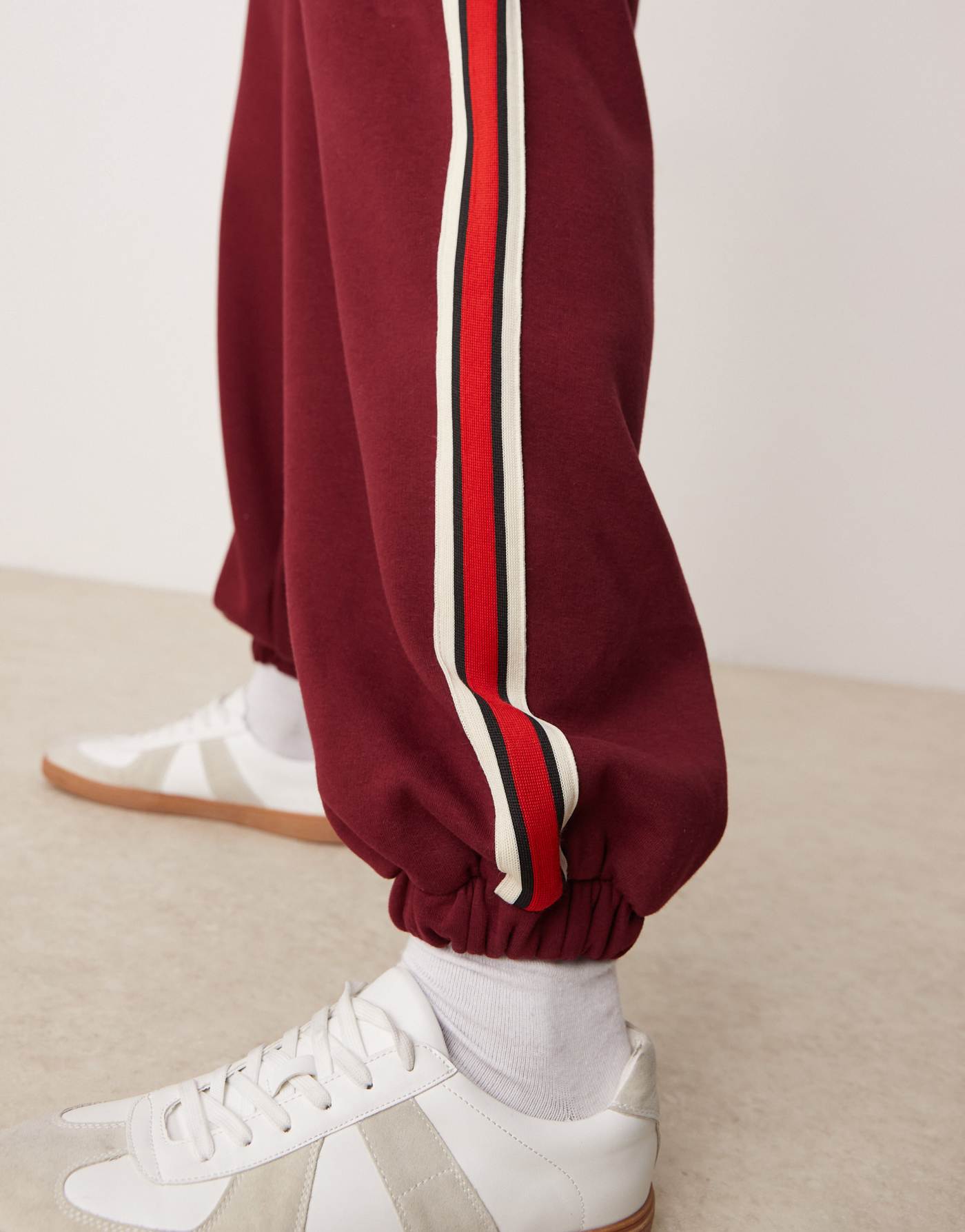 ASOS DESIGN oversized balloon jogger with taping in burgundy