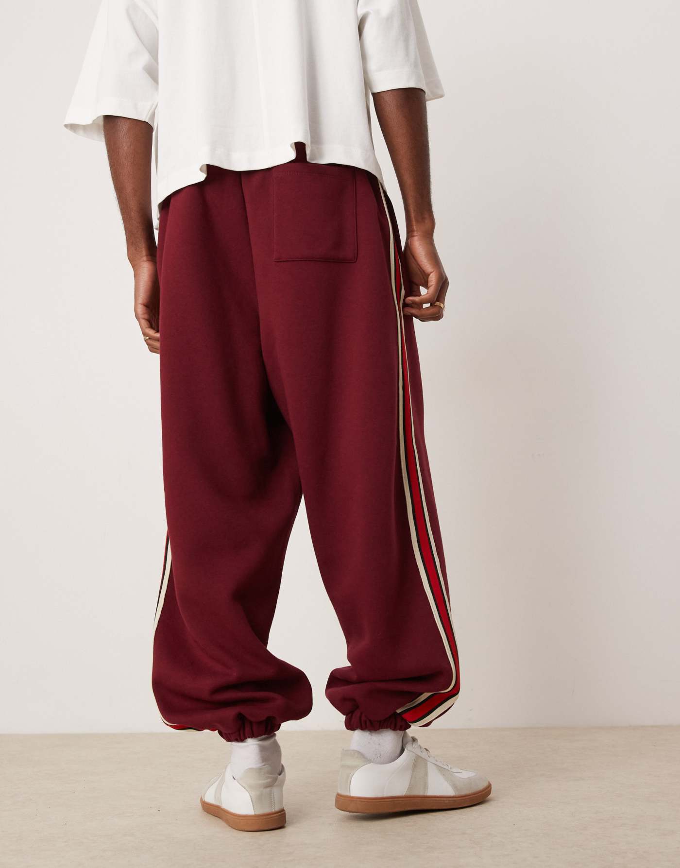 ASOS DESIGN oversized balloon jogger with taping in burgundy