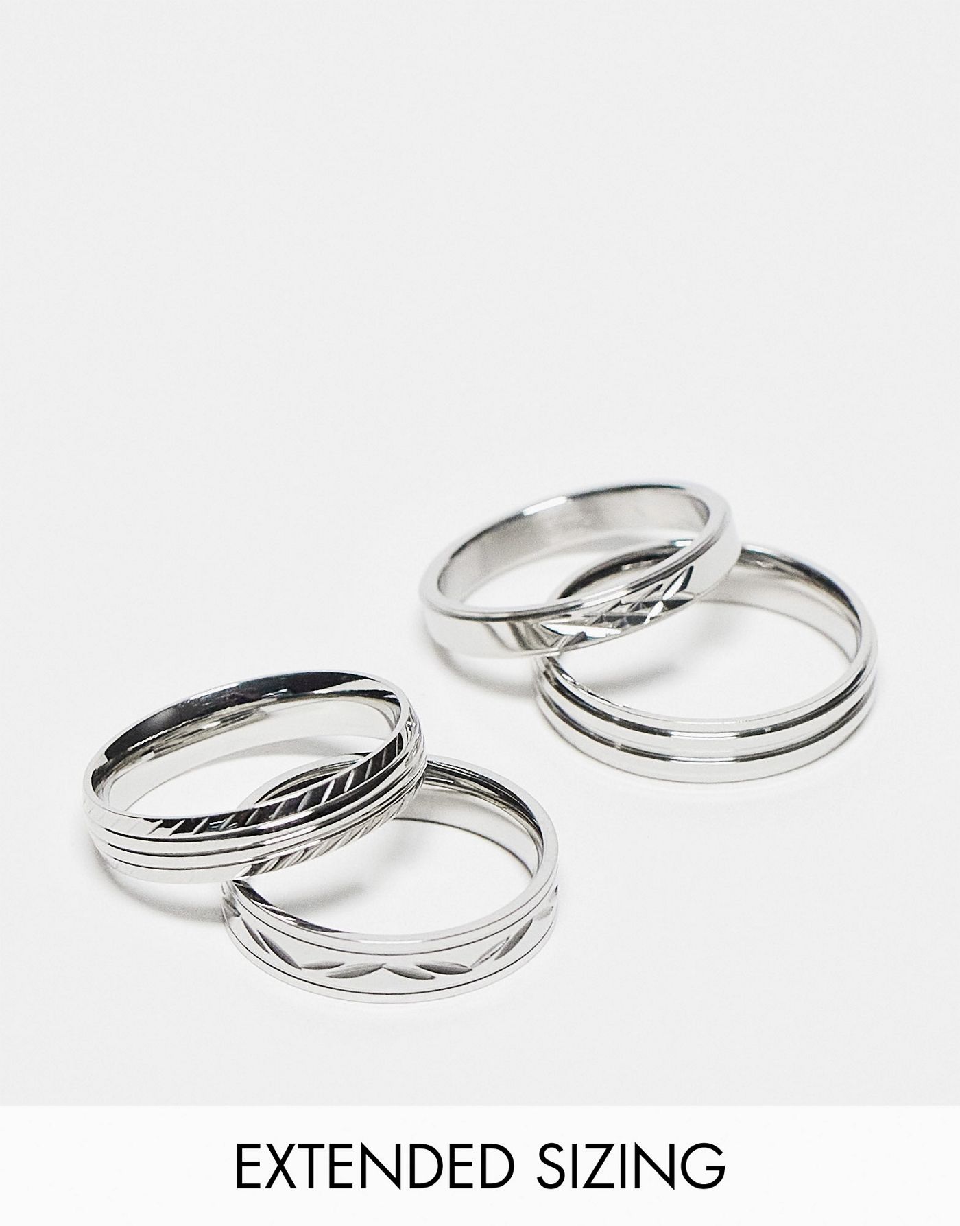 ASOS DESIGN 4 pack waterproof stainless steel skinny band ring set with embossing detail in silver tone